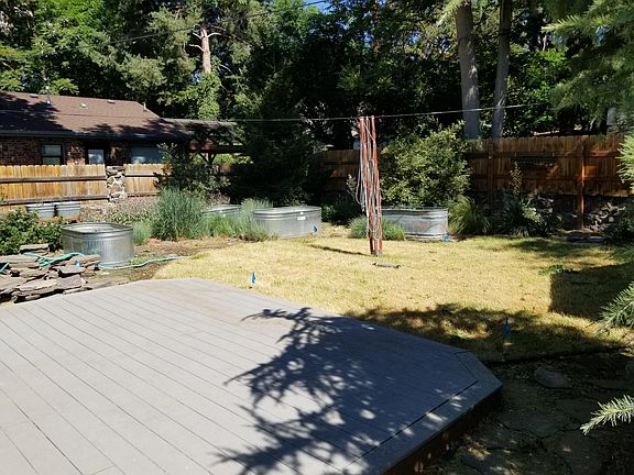 Deck, planters and clothes drying system. stone walls with fence for privacy.
