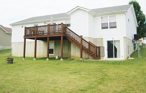 Large fenced in back yard with deck and patio.