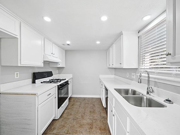 kitchen with new quartz countertops & new sink with hose sprayer. also a new dishwasher.
