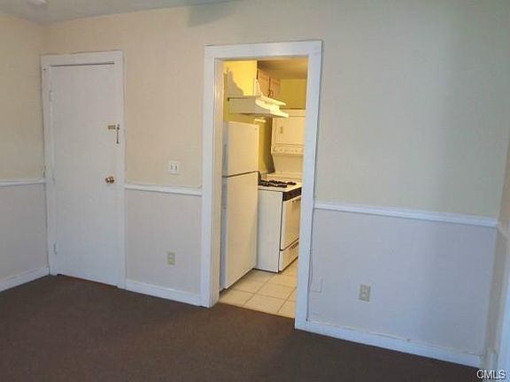 The entrance to the kitchen from the living room. The dooron the left leads to the downstairs front door.