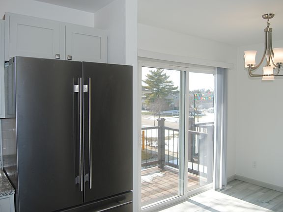 Kitchen dining area with sliding door leads to new balcony
