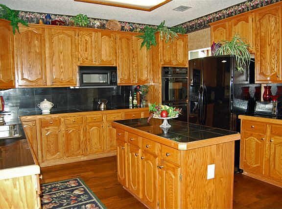 Kitchen with lots of cabinets, granite counter tops, hand scraped hardwds flr