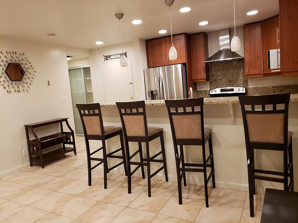 Looking from living room to front door and kitchen