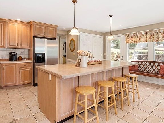 Newer kitchen with tiled floor and stainless steel appliances