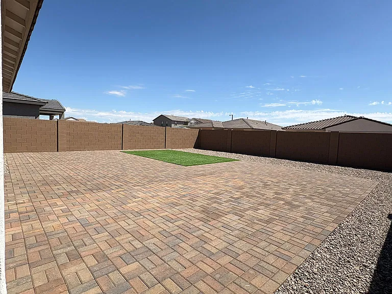 Backyard Almost full Pavers And Artificial Turf
