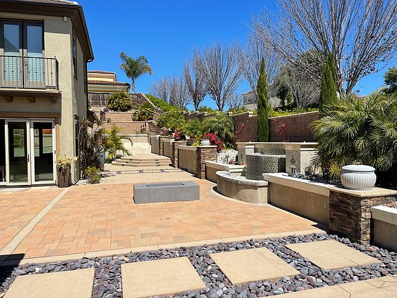 Indulge in the beauty of the connected patio, adorned with lush landscaping.