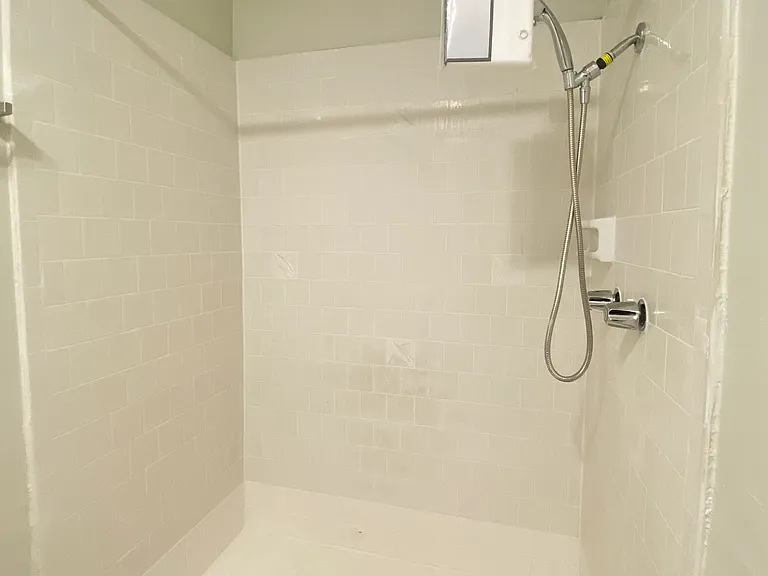 The ensuite bathroom has a spacious, extra large shower