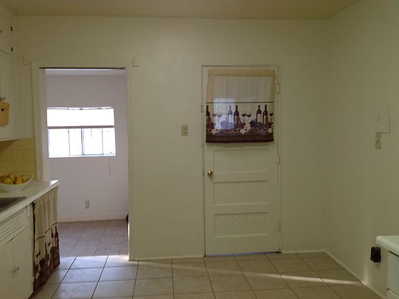 Kitchen/dining area with refrigerator and stove. Tile floor and skylight.
Laundry room with washer & dryer.