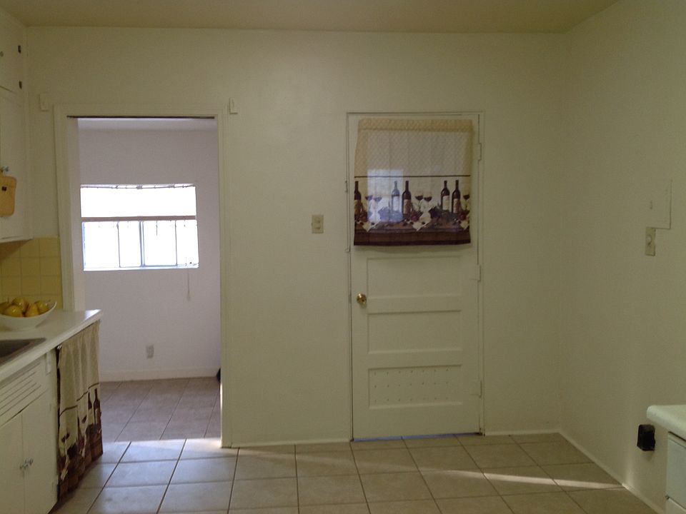 Kitchen/dining area with refrigerator and stove. Tile floor and skylight.
Laundry room with washer & dryer.