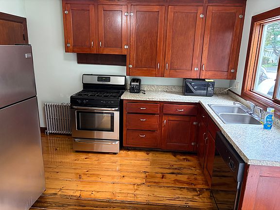 Kitchen with gas stove, dishwasher, and garbage disposal.