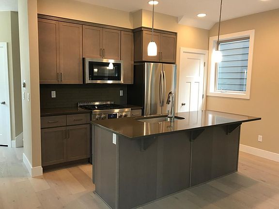 Modern kitchen with stainless steel appliances and walk-in p