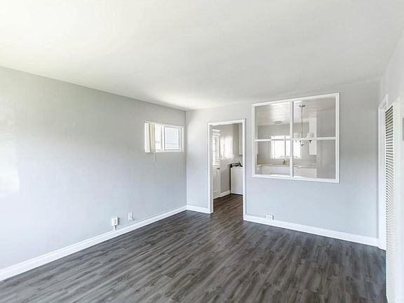Front living area with natural light, separate from Kitchen with open space for entertaining .