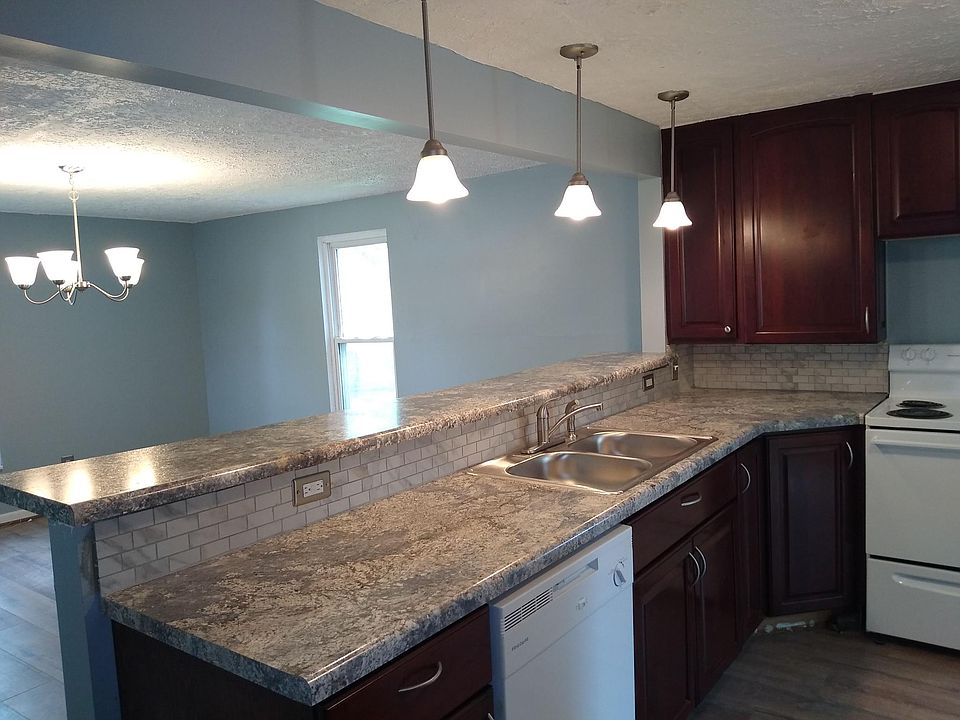 Fully remodeled kitchen open to dining room with breakfast bar.