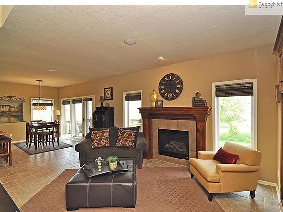 Sun filled kitchen opens to the hearth room and spectacular covered deck