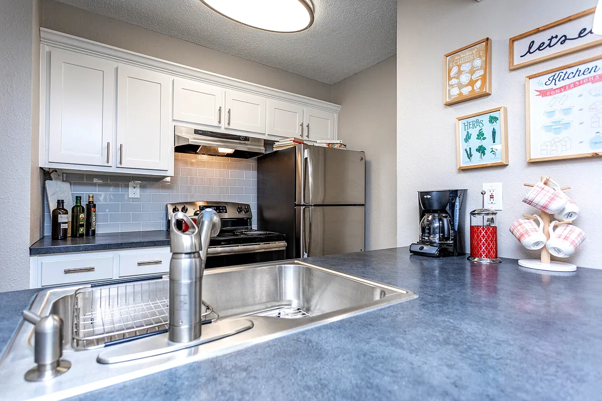 Modern apartment kitchen with stainless steel appliances at Domain Apartments in Norcross, GA - Domain Apartments