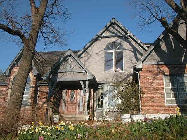 The front: mature trees, 30 feet of yard, flower and saffron beds