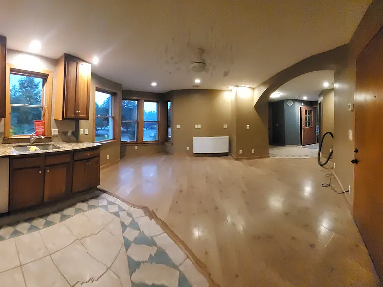 Panoramic view into living area and kitchen from kitchen
