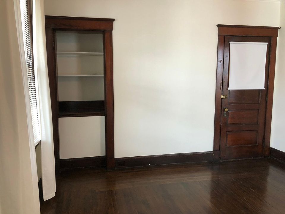 Living room. Shelving unit. Door is the entrance to the apartment from the hall.