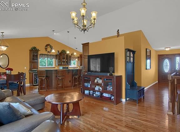 Open floor plan with hardwood flooring and fresh paint