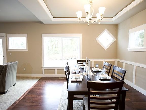 Tall 9ft coiffured ceilings and hardwoods add elegance to this dining room 