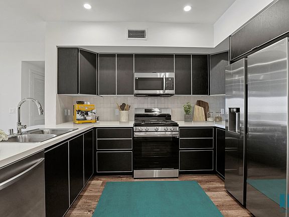 Kitchen with Stainless-Steel Refrigerator, Stove, Microwave Oven, and Dishwasher