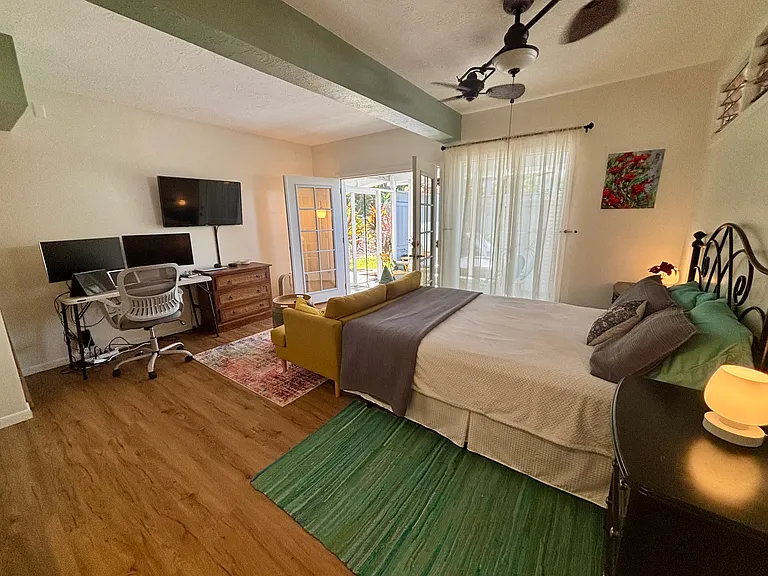 Private indoor studio living area with double french door opening up to the covered screened in private lani with ocean breezes