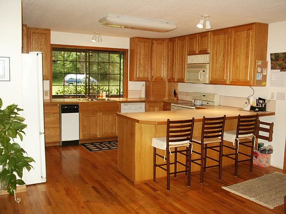 Large kitchen with custom cabinets & breakfast bar