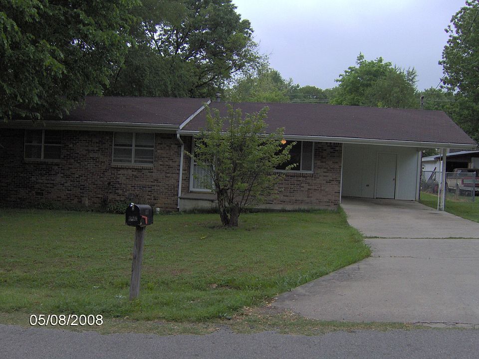 The school bus stops in front of the home.