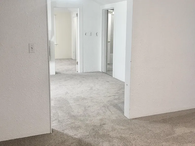 From the 2nd living space looking through the main living room into the bedroom.