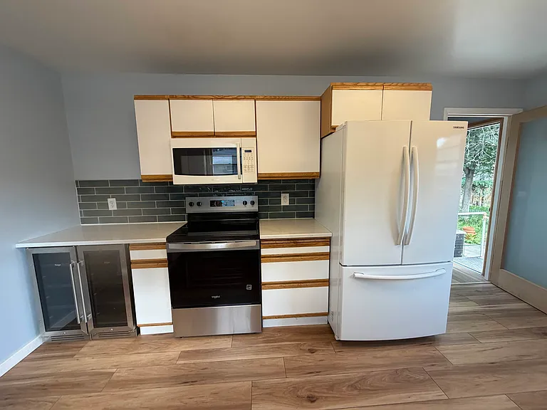 Kitchen showing beverage fridges
