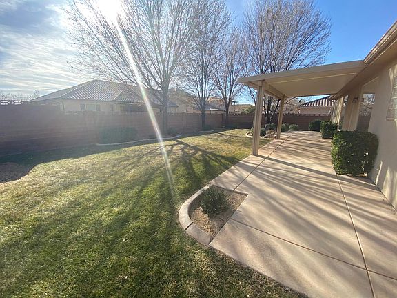 Covered patio in backyard. Lots of grass space.