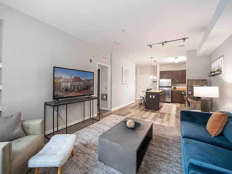 a living room with a couch and a tv at Harbor Pointe, Bayonne, New Jersey