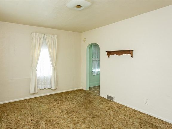 Neutral Decor in the living room which leads into the kitchen.