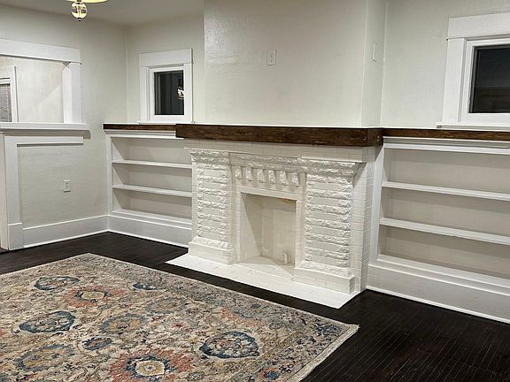 Faux fireplace w/mantle and loads of book shelves .