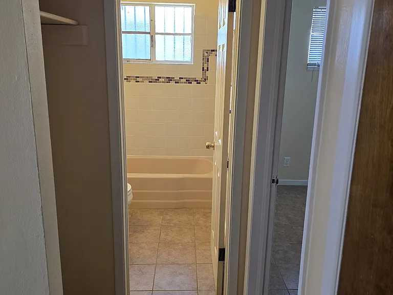 Hall looking into Bathroom. Another Hall Closet on right