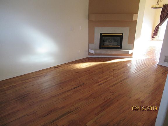 Living room with Hardwood flooring and Gas fireplace. 1/2 bath is attached to this Living room