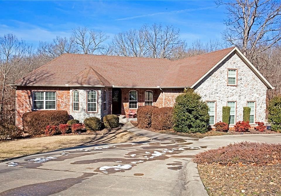 Three car garage on right with large parking area