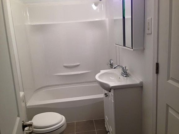 new tub and surround, new medicine cabinet, new tile floor a