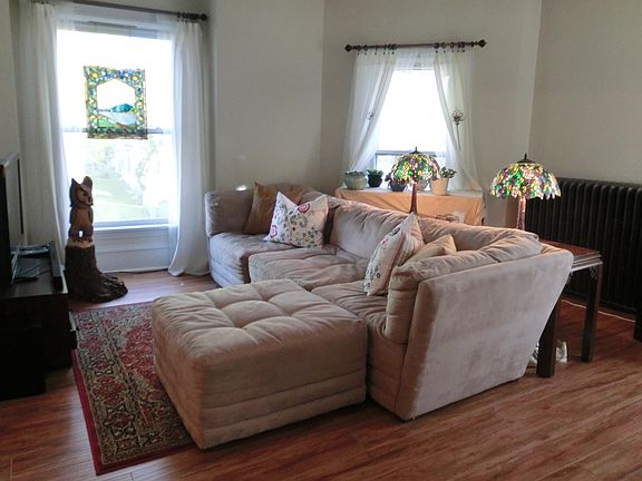 Large living room with huge windows in front bay.