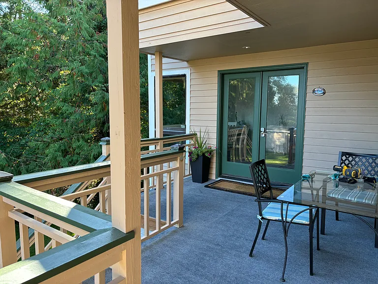 Deck with eating area with water view.