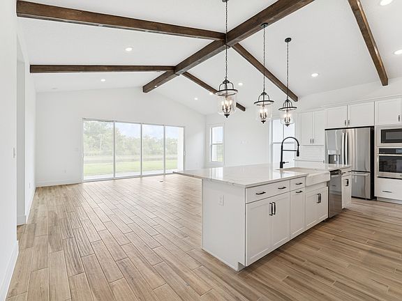 Soaring vaulted ceiling unites main living spaces