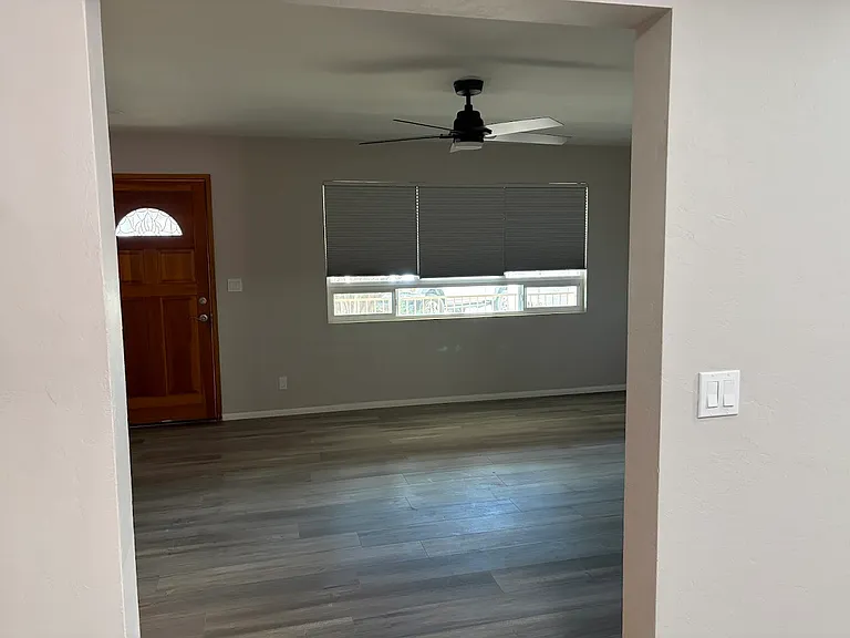 Living Room looking from dining area. Front door faces west