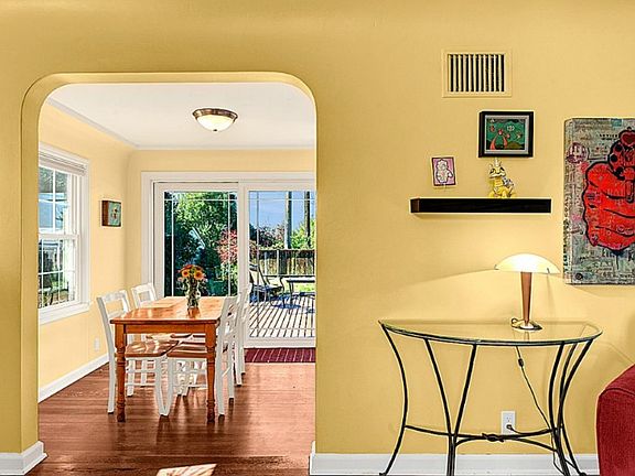 Living room opens to sunny dining room.