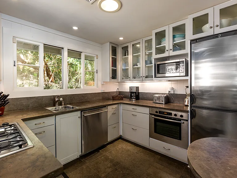Gourmet kitchen with with gas burners and fully equipped appliances