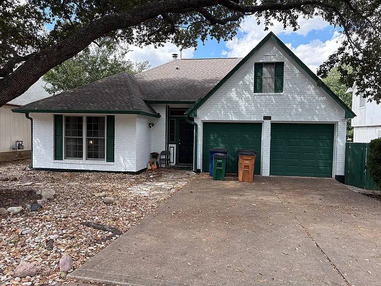 Front of house, large live oak in front yard; freshly painted exterior.