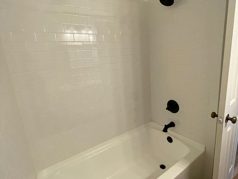 New tub with hand laid tile surround and new fixtures