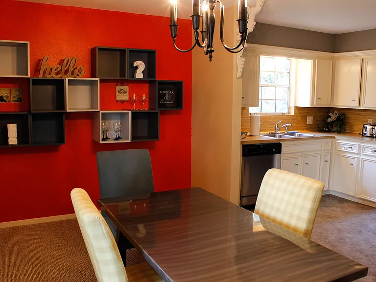 Dining Area, showcasing steel dining table and decorative wall-cubes.