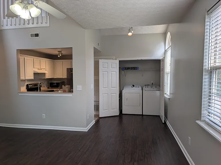 Dining area with in-unit washer/dryer closet and kitchen pass-through