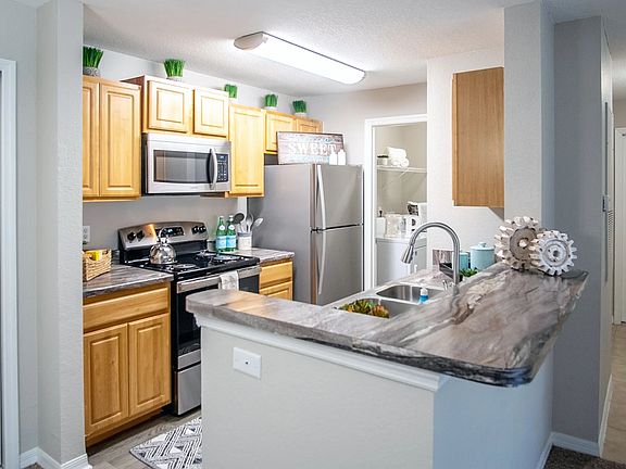 Embrace open-concept living at Eagle's Pointe, where the breakfast bar delightfully opens to the living area.