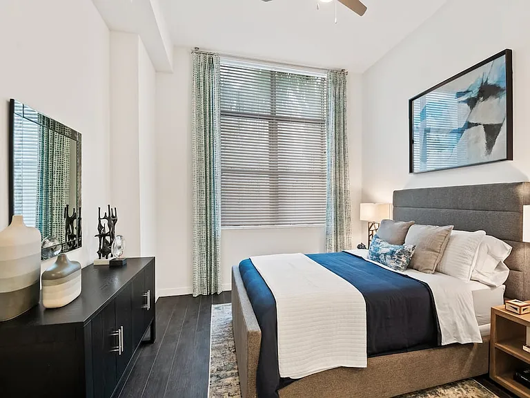 Bedroom with ceiling fan and hard-surface vinyl plank flooring